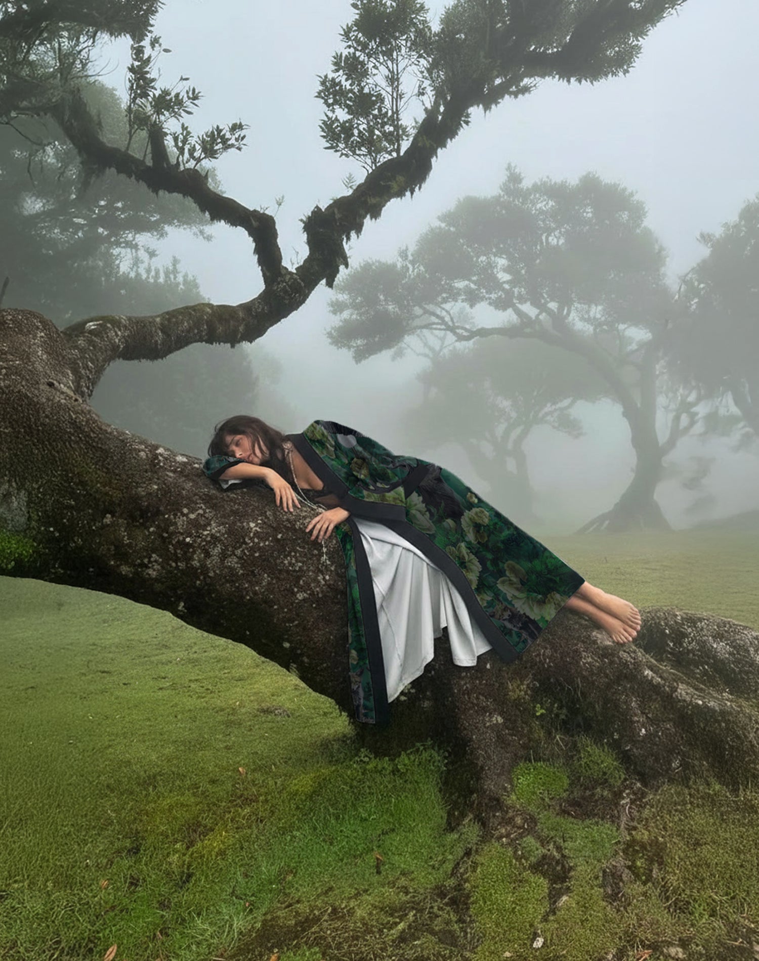 a woman laying on a tree wearing a elegant kimono robe