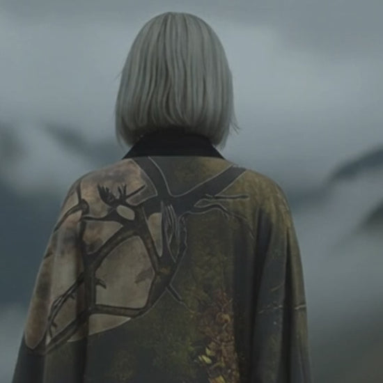 Elegant statement kimono inspired by nature, featuring soft greens and warm tones of an afternoon in the woods