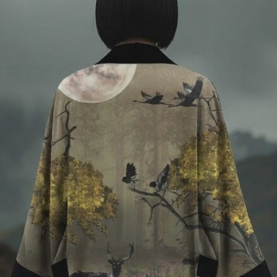 Elegant designer kimono in dark tones with golden botanical pattern, powerful outdoor forest nights fashion portrait